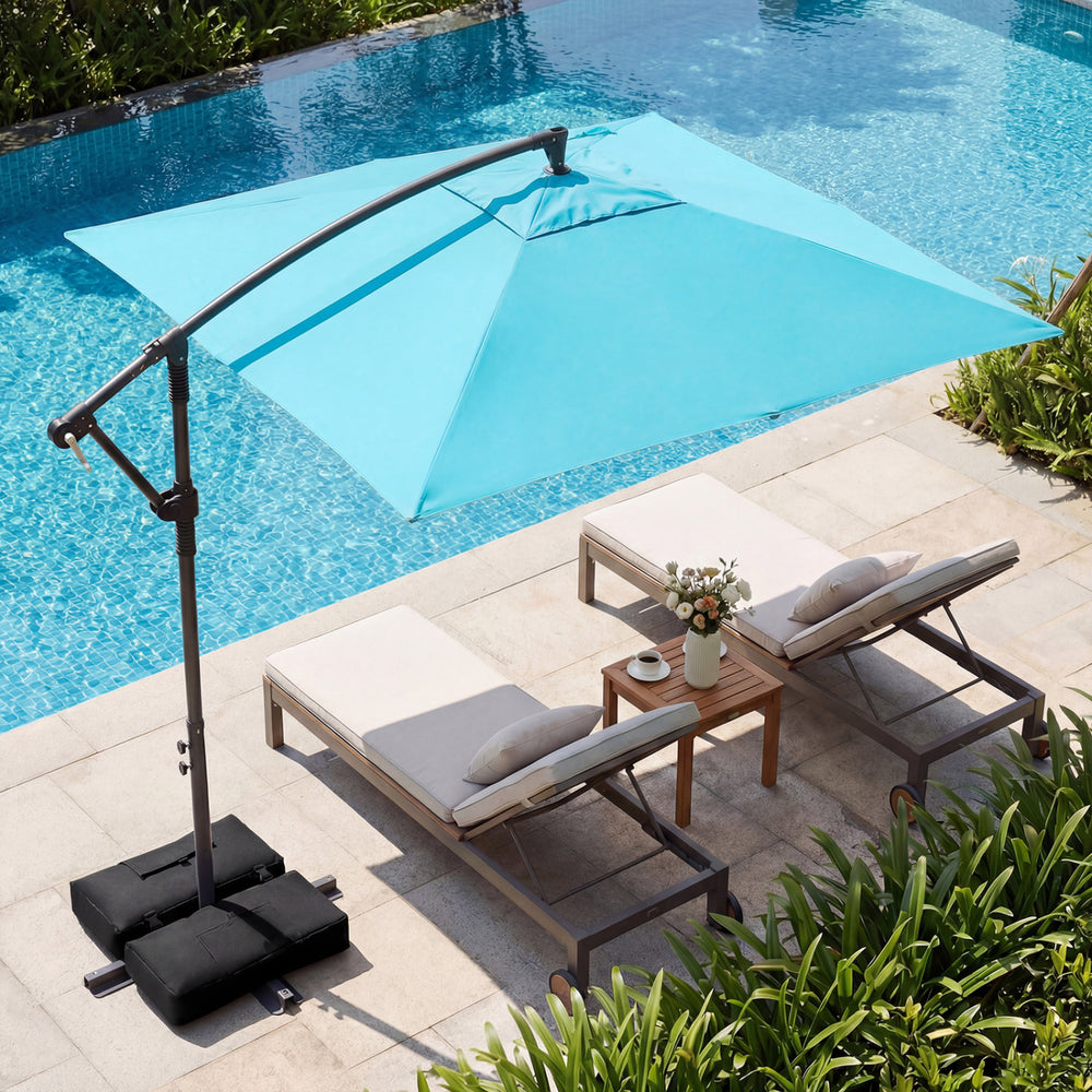 Turquoise 8 x 8 ft offset cantilever patio umbrella with 360° rotation, providing shade for outdoor lounging by the.