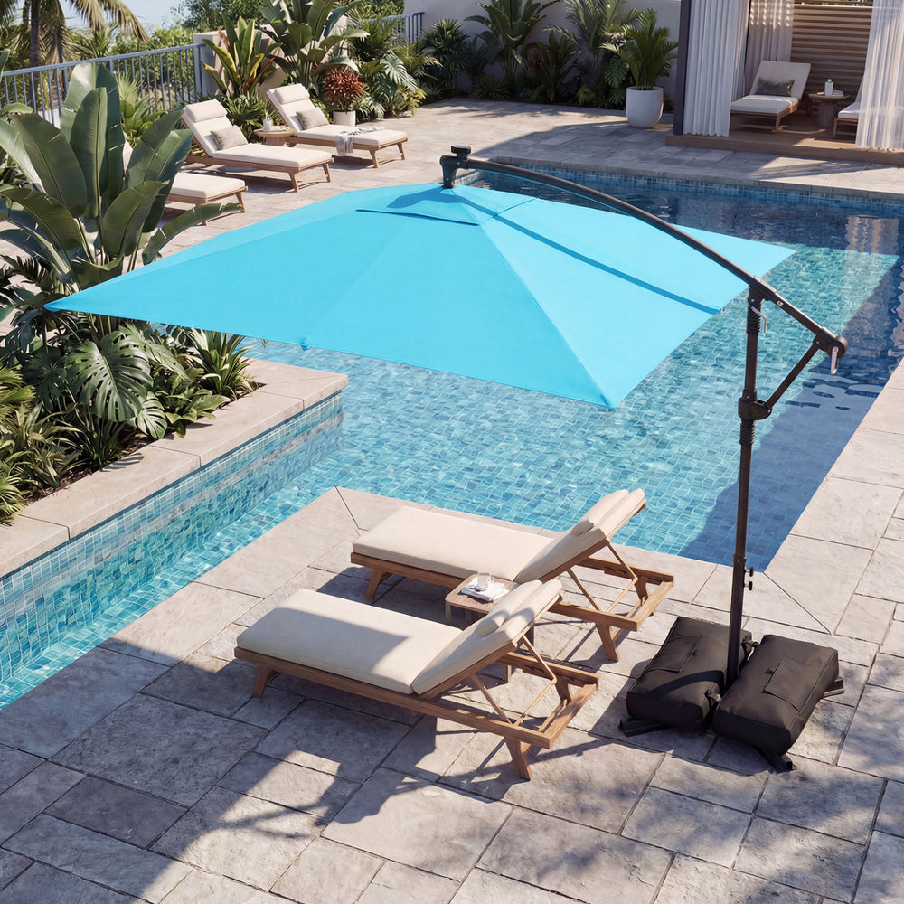 Turquoise 8 x 8 ft solar LED offset cantilever patio umbrella with 360° rotation, providing shade by the poolside.