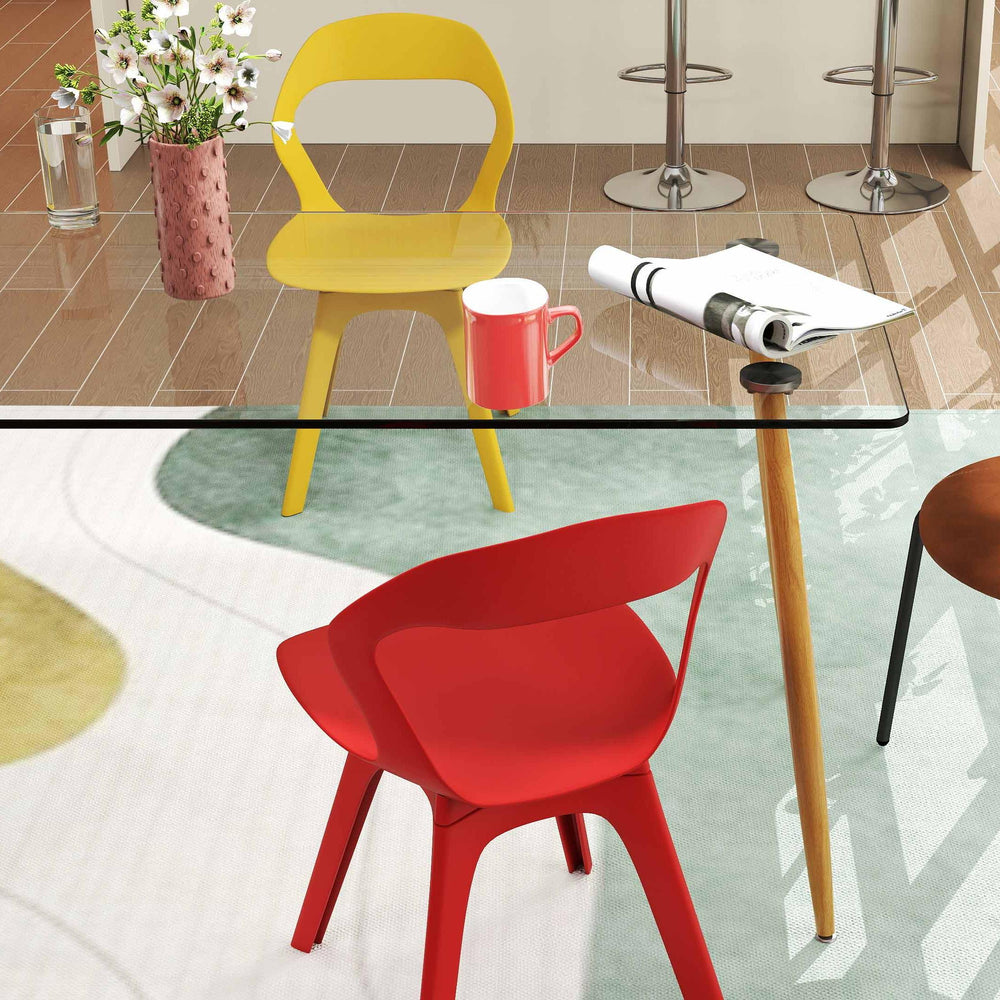 Red and yellow mid-century dining chairs from a modern dining set, perfect for stylish kitchen or bar seating.