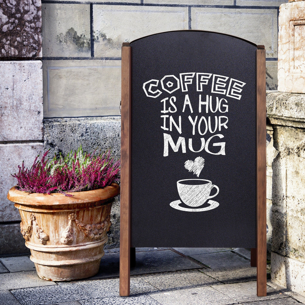 A-Frame chalkboard sign displaying "Coffee is a hug in your mug," ideal for sidewalk advertising and promotions.