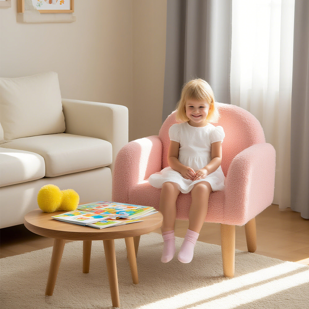 Kids armchair in pink with comfy backrest and armrests, covered in soft teddy fleece, perfect for home or kindergarten.