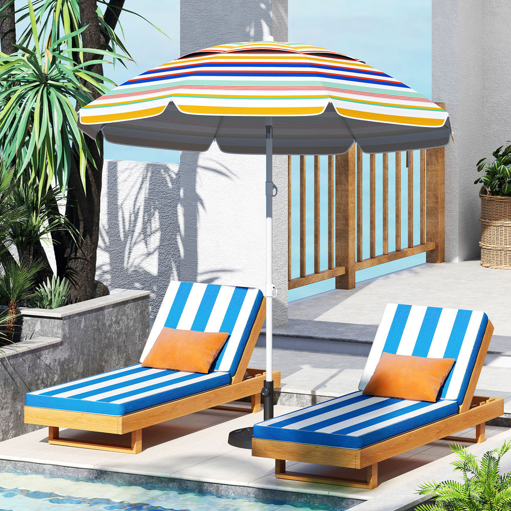 Colorful 6.5 feet beach umbrella with UPF50+ sun protection, tilted for shade, beside two lounge chairs by the pool.