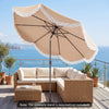 Outdoor tassel umbrella with push button tilt in white, providing shade for patio seating area with ocean view.
