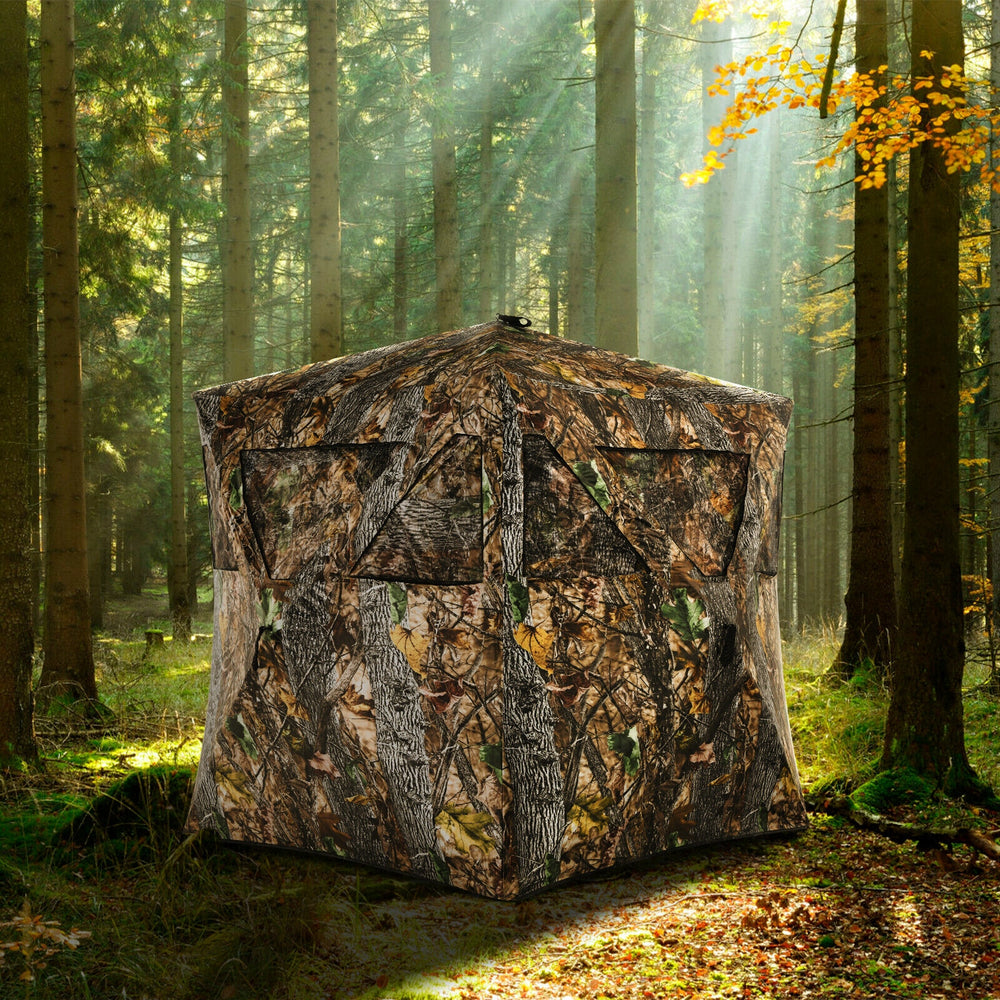 3-person portable pop-up hunting blind with vivid camouflage, multiple windows, and tie-downs for stability in the.
