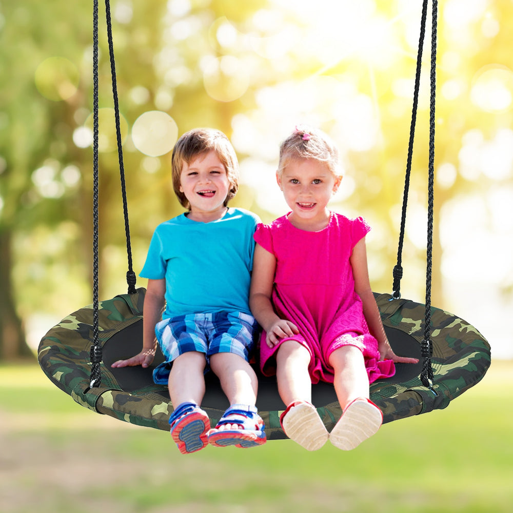Kids enjoying the 40-inch flying saucer tree swing, featuring durable fabric and adjustable ropes for outdoor fun.