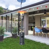 Gray propane outdoor heater with table and wheels, 87" tall, providing warmth for patio gatherings.