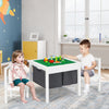 Kids sitting at a white activity table set, engaging with building blocks and enjoying a creative playtime experience.