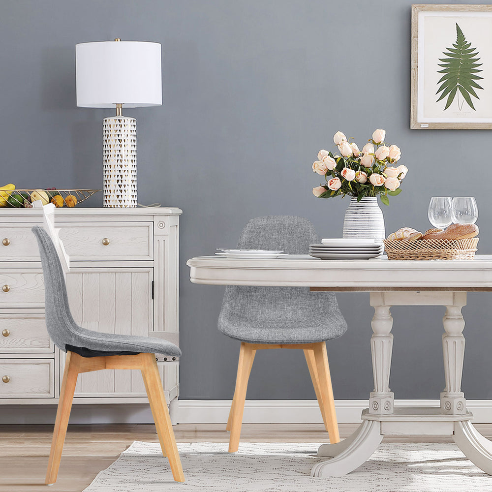 Modern dining chair set with wood legs and fabric cushion seat, featuring ergonomic backrest for comfort in a stylish.