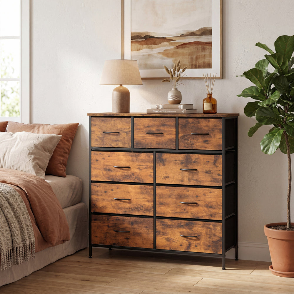 9-drawer fabric dresser with a rustic brown wooden top, styled in a cozy bedroom setting with a lamp and plant.