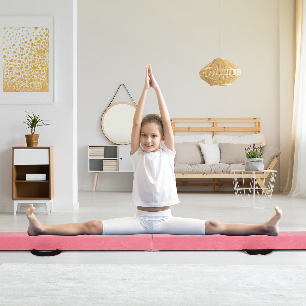 Folding gymnastics balance beam in pink with a child performing a split, featuring a sturdy pine wood frame for.