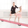 Two young gymnasts practice on a pink folding balance beam with a pine wood frame, enhancing their balance skills.