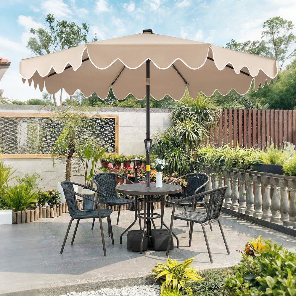 9 FT outdoor patio umbrella in brown with solar LED lights, tilted for optimal shade, set in a stylish garden.