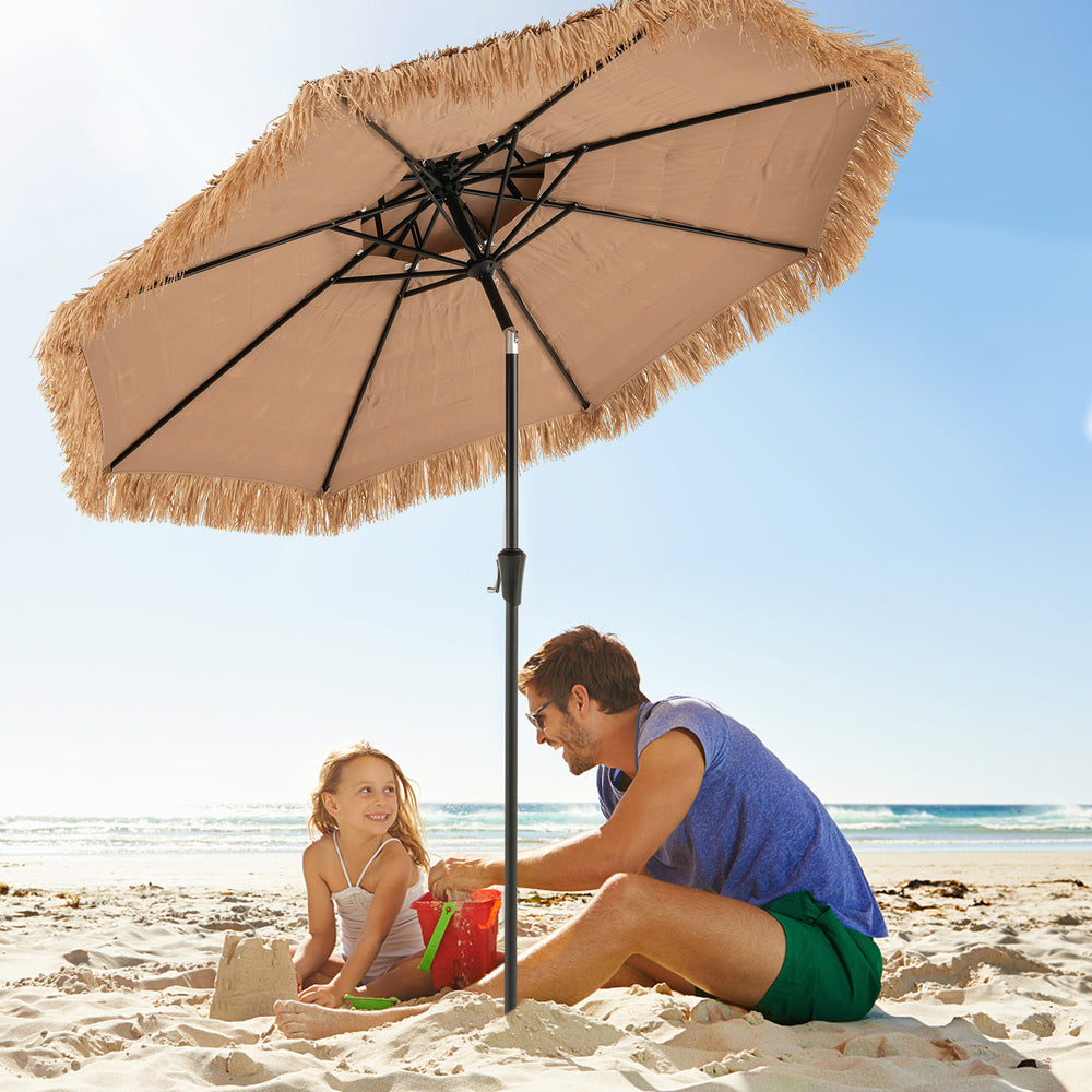 9-foot thatched tiki umbrella with 8 ribs, providing shade for beach relaxation and outdoor decor.