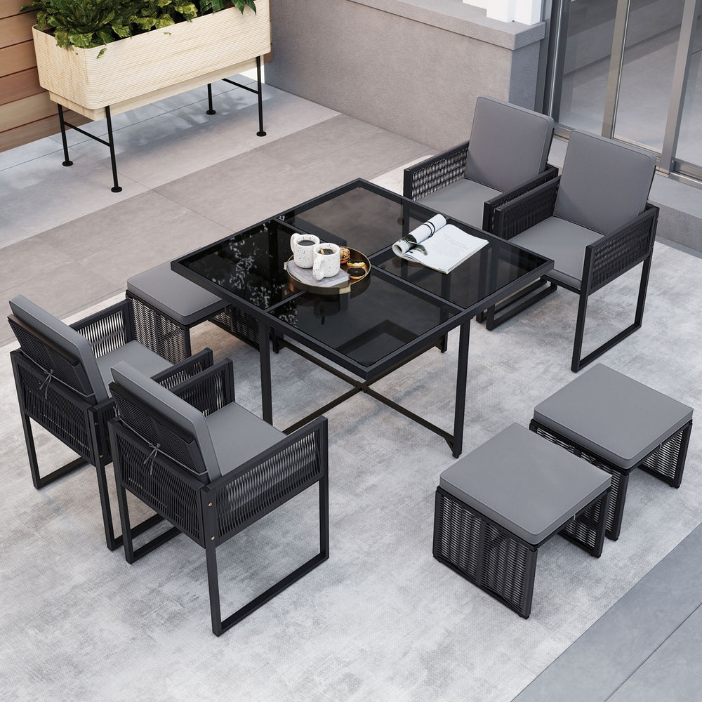 9-piece patio dining set featuring gray cushions, PE rattan chairs, and a tempered glass tabletop for outdoor.