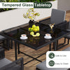 Tempered glass tabletop of a 9-piece patio dining set with gray cushions, ideal for outdoor dining and easy cleaning.