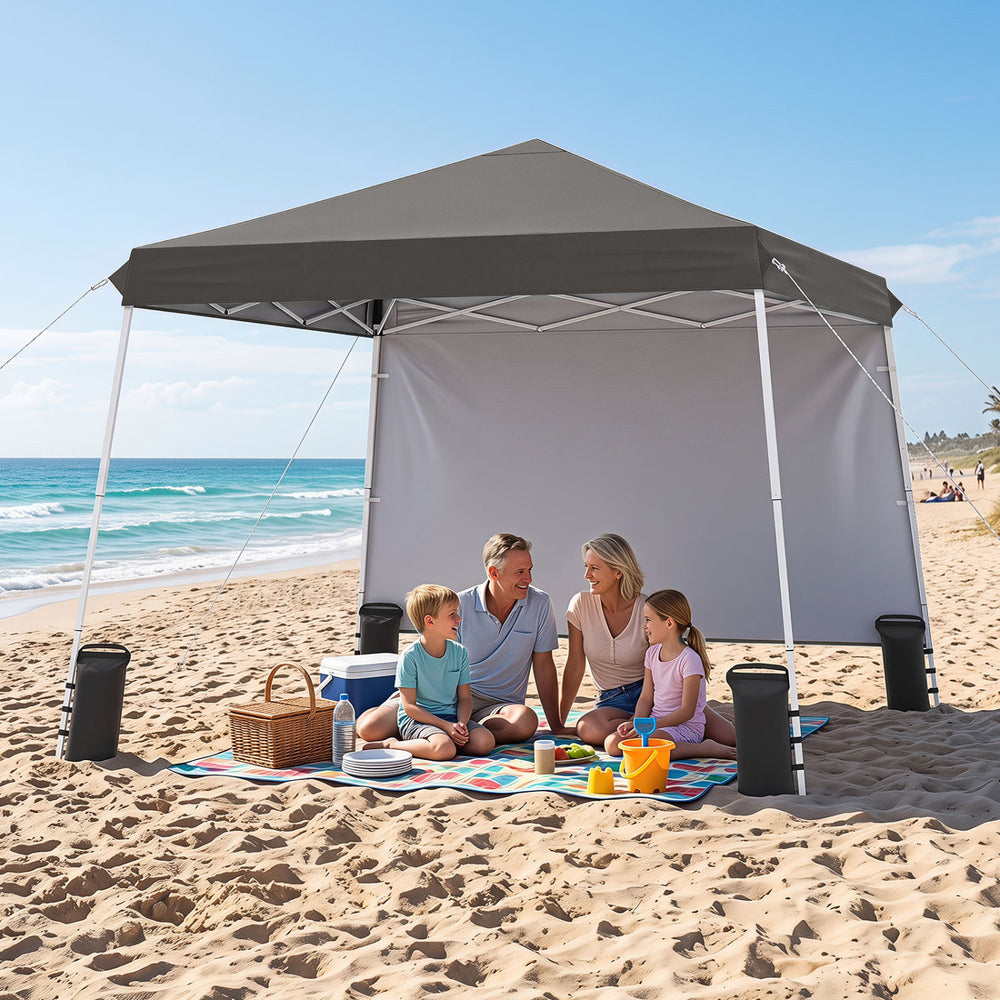 Pop up canopy tent in gray, 9 ft x 9 ft, provides sun protection for outdoor gatherings at the beach or park.
