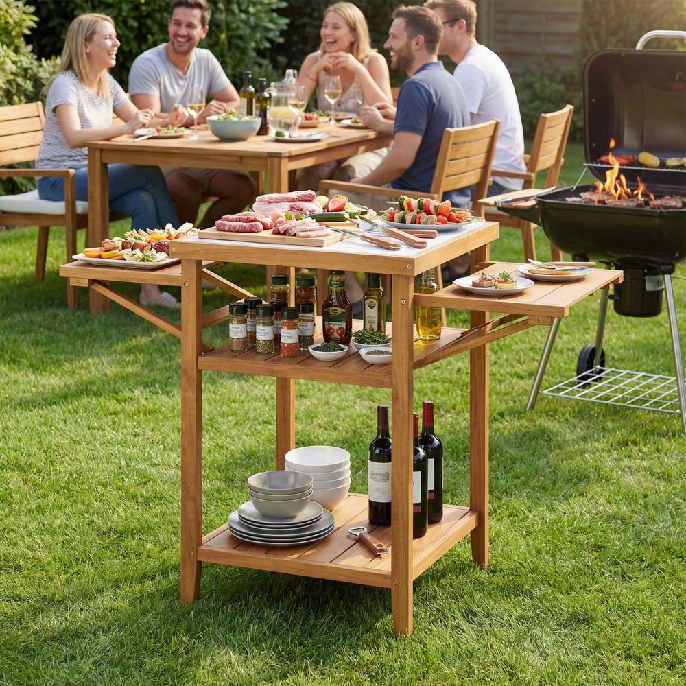 Acacia wood outdoor grill table with faux marble top, featuring drop-leaf side panels for extra prep space, perfect for.