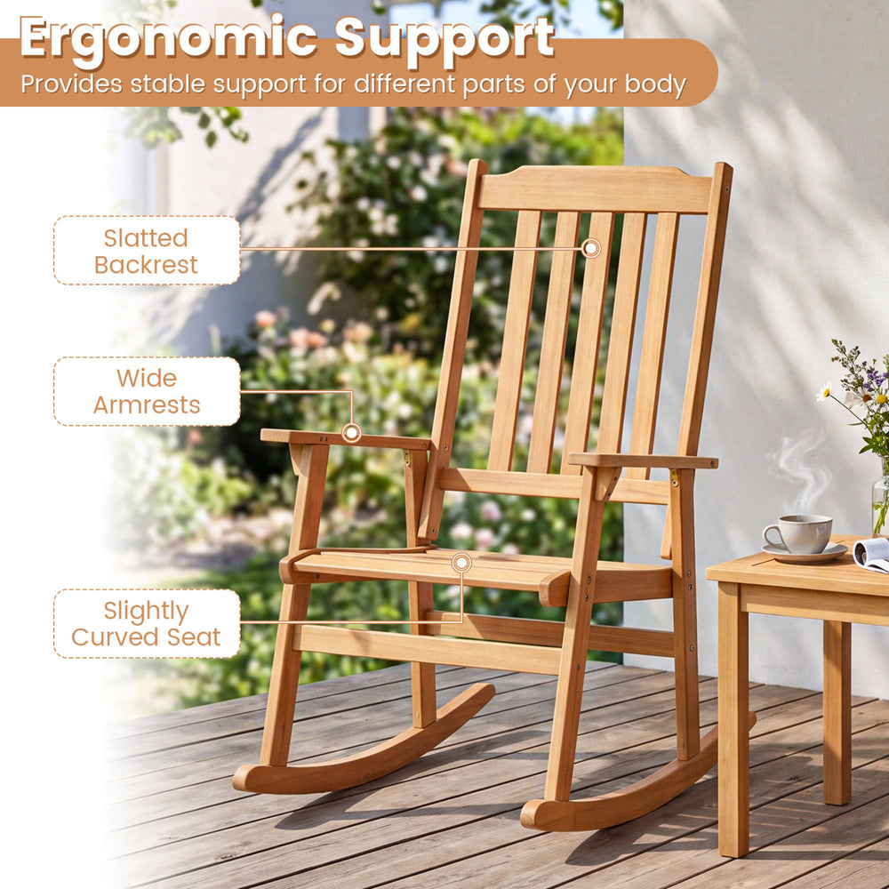 Oversized acacia wood rocking chair with slatted backrest and wide armrests, perfect for outdoor relaxation on porches.