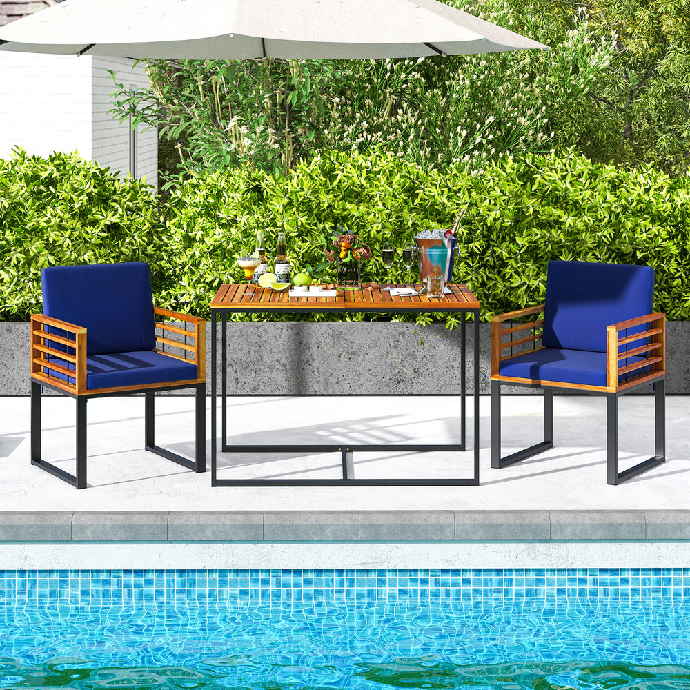 Acacia wood patio dining table with metal frame, navy chairs, perfect for outdoor dining by the pool.