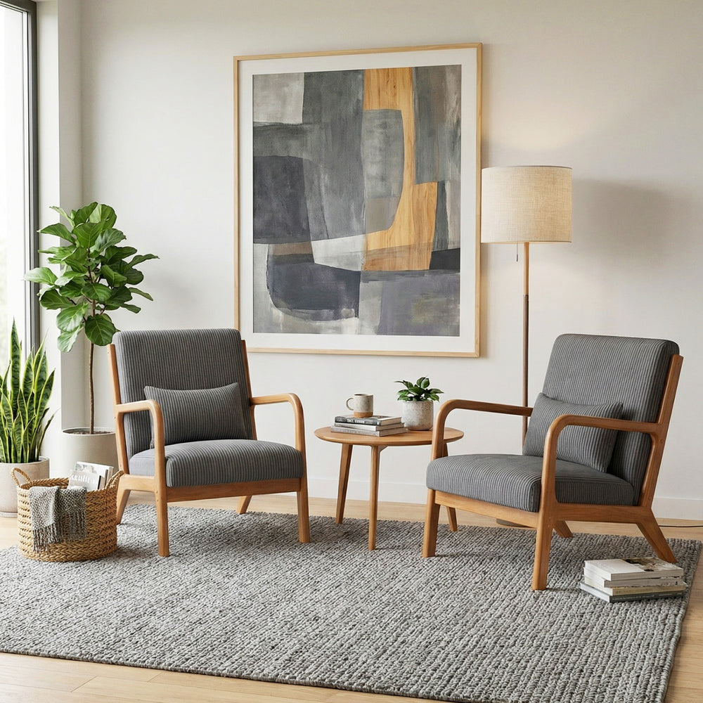 Gray corduroy accent chairs with lumbar pillows and solid wood frames, ideal for cozy living rooms or reading areas.