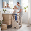 Adjustable 3-step helper stool in gray with safety handles, perfect for kids to reach sinks and counters confidently.