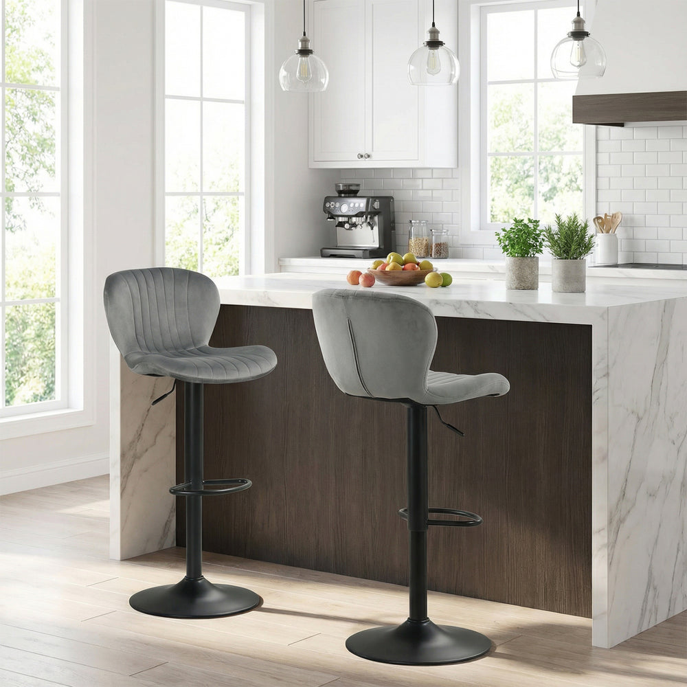 Adjustable gray velvet counter height chairs with 360° swivel and round metal base, ideal for modern dining spaces.