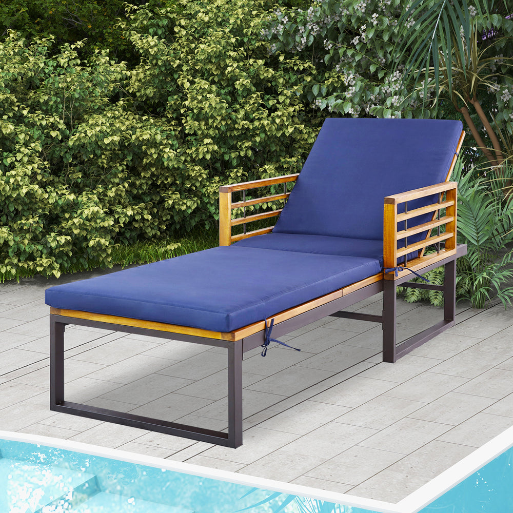 Adjustable cushioned patio chaise lounge chair in navy with a sturdy acacia wood frame, ideal for poolside relaxation.