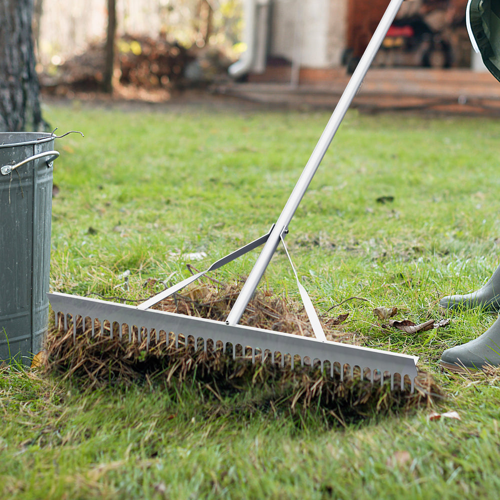 Aluminum rake with a 36-inch head, shown collecting debris, features a lightweight design and comfortable 68-inch.