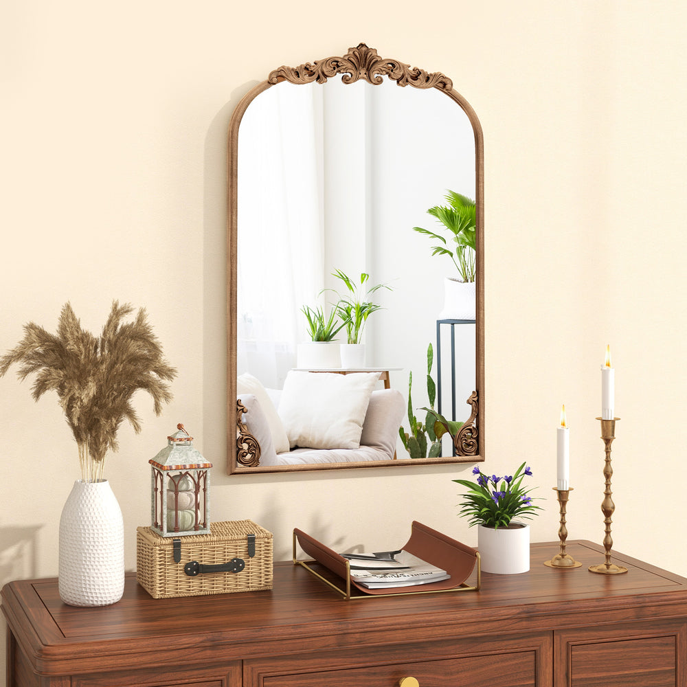 Arched vintage gold metal frame mirror with ornate baroque design, perfect for entryways and living rooms.