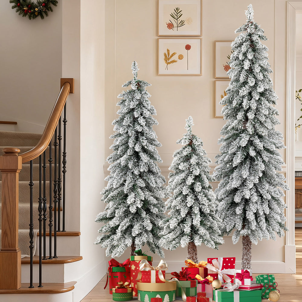 Three artificial Christmas trees with snow-flocked branches, featuring multi-color LED lights for festive indoor.