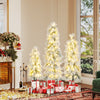 Three artificial Christmas trees with snow-flocked tips and warm white LED lights, perfect for holiday decor.