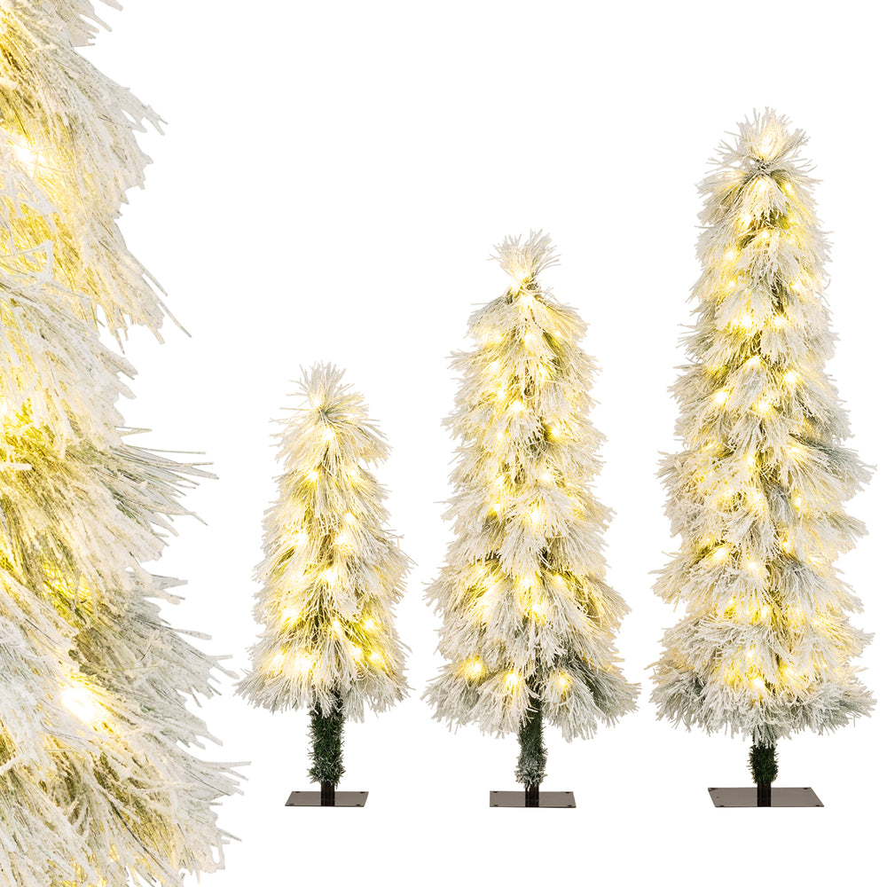 Close-up view of snow-flocked branch tips on a tall artificial Christmas tree, featuring warm white LED lights for a.