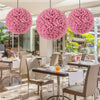 Three 17.5-inch faux pink eucalyptus decorative balls hanging above a dining area, ideal for garden and wedding decor.