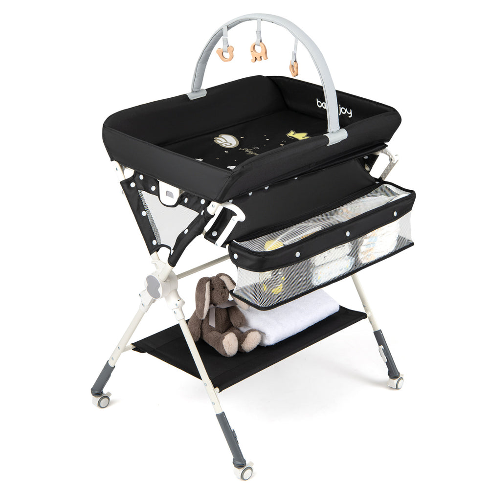 Foldable black baby changing table with storage bag, adjustable height, and removable toy bar for easy diaper changes.