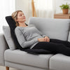 Back massager seat cushion in black with adjustable straps, designed for relaxation on a sofa or chair.