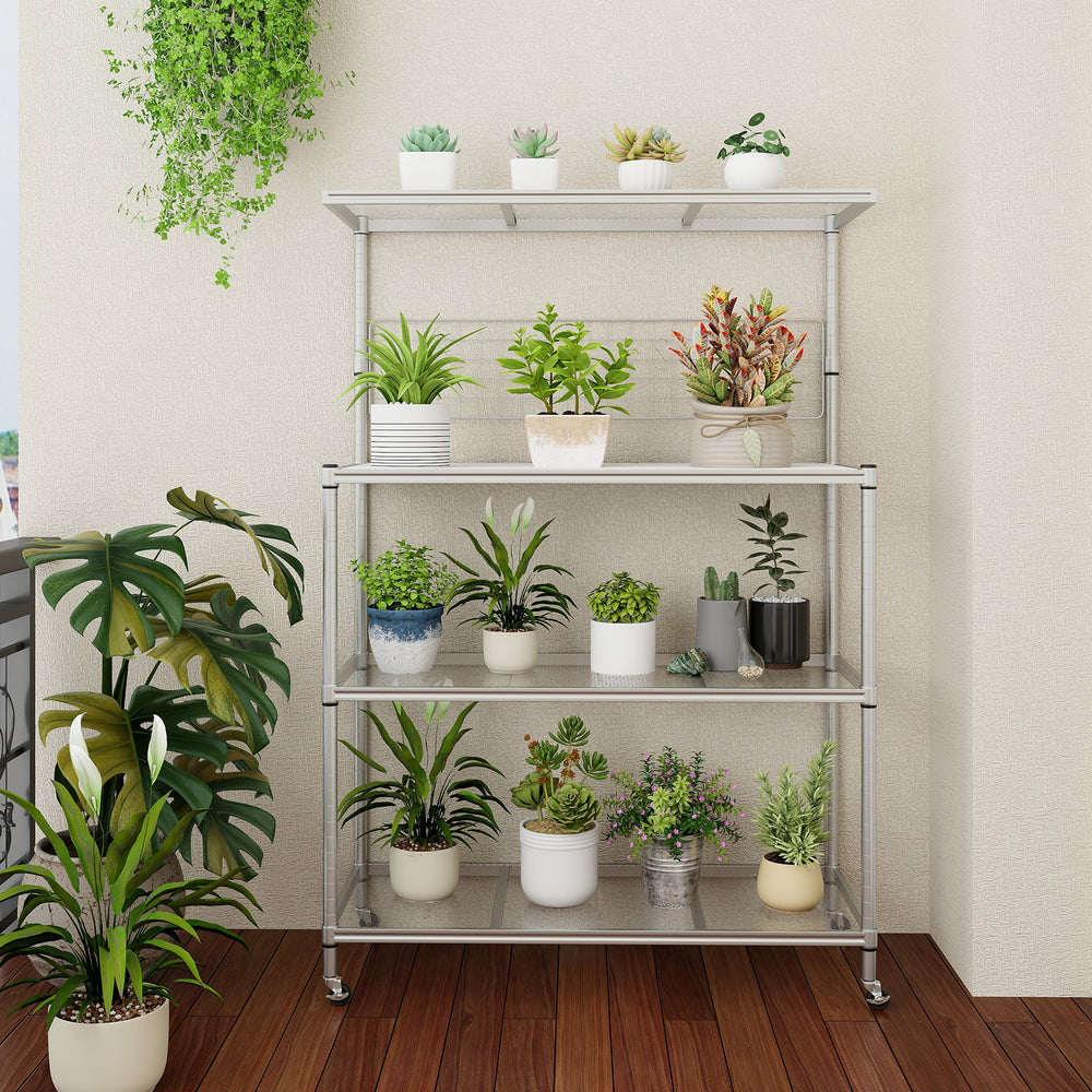Front view of the 4-tier bakers rack on wheels in silver, displaying potted plants and ample storage space for kitchen.