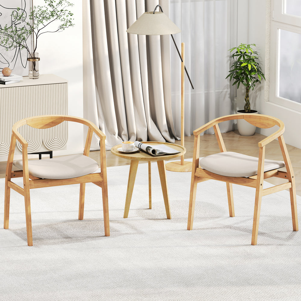 Bamboo accent chairs with armrests and curved backrests, featuring soft cushions for comfort in a cozy living space.