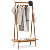 Bamboo clothes rack with hanging rod, rattan shelf, and copper hooks, ideal for organizing coats and accessories.