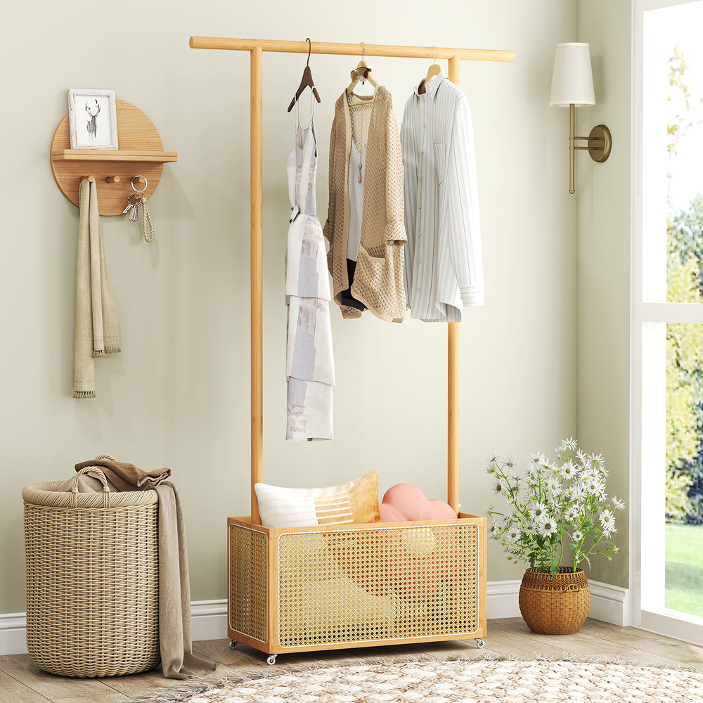 Bamboo clothes rack with hanging rod and rattan storage basket on wheels, ideal for entryway or bedroom organization.