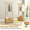 Bamboo clothes rack with rattan storage basket and wheels, featuring a natural finish for stylish organization.