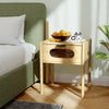 Bamboo nightstand with decorated drawer and reeded glass, featuring a spacious tabletop for bedside essentials.