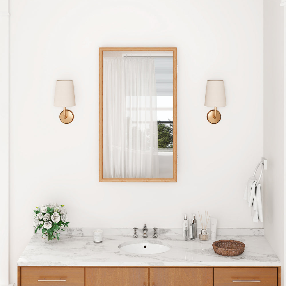 Bamboo small medicine cabinet with mirror door, showcasing a sleek design and varnished surface in a bathroom setting.