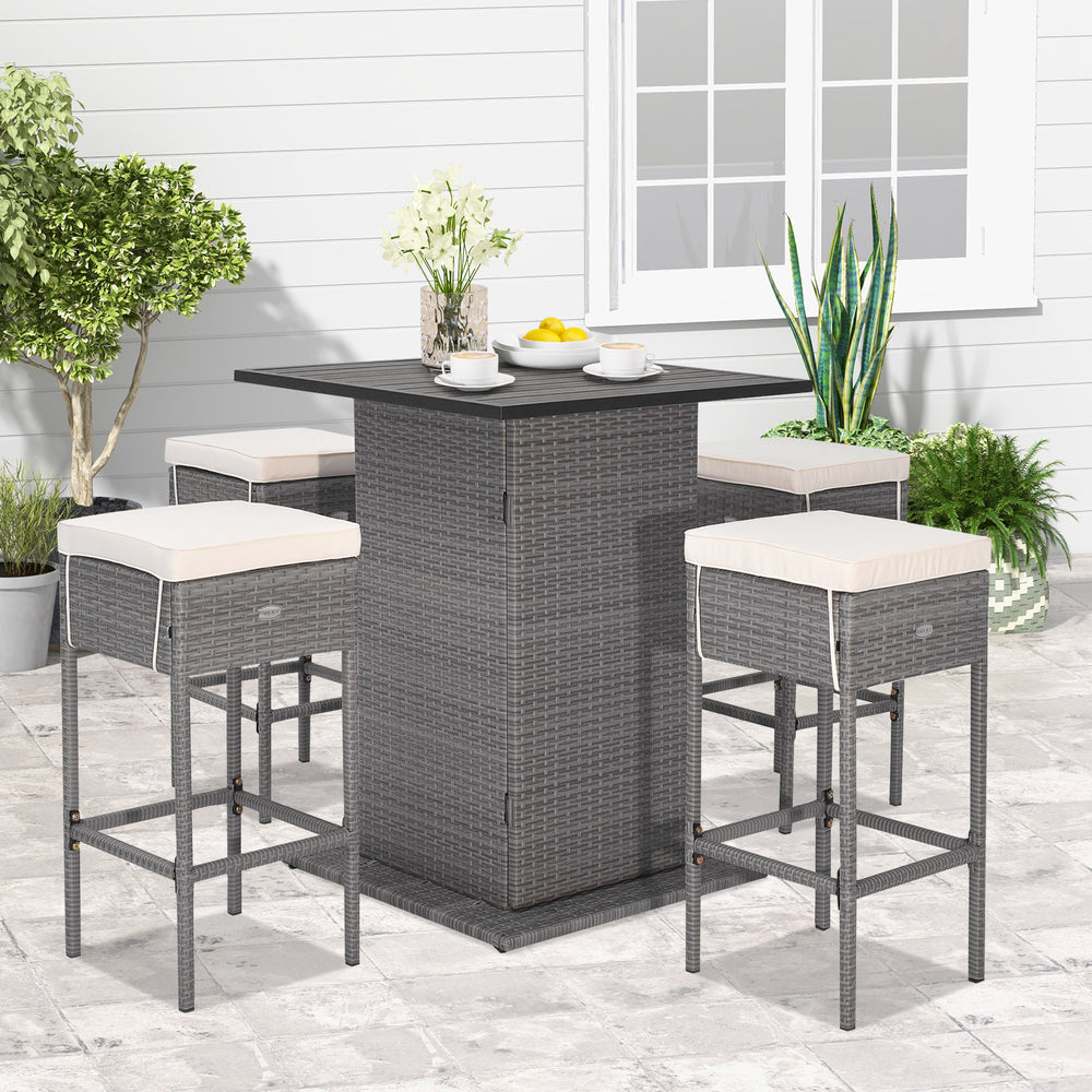 5-piece outdoor wicker bar table set with hidden storage, soft cushions, and ergonomic footrests for patio relaxation.
