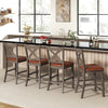 Set of two gray bar stools with cross back and faux leather upholstered seats, perfect for kitchen or dining areas.