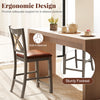 Gray bar stool with cross back and faux leather seat, featuring ergonomic design and sturdy footrest for comfort.
