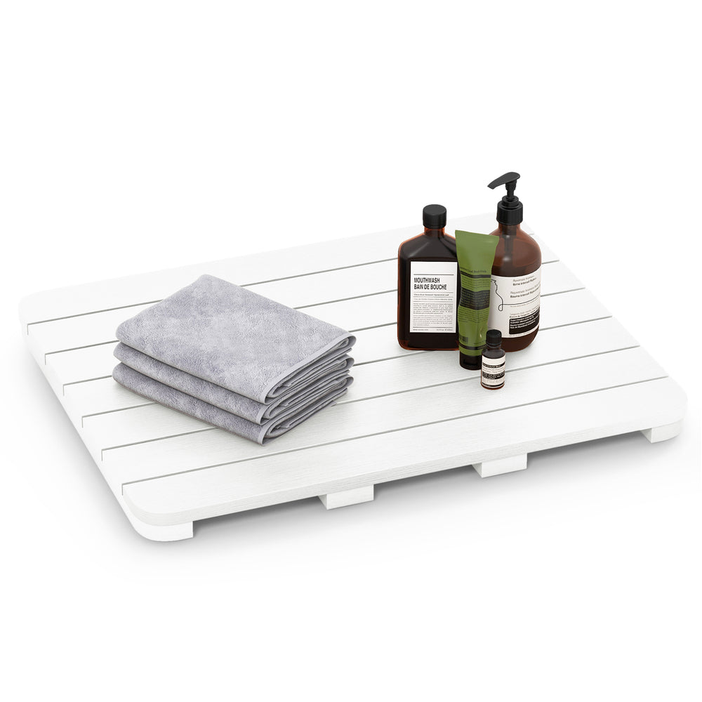 White waterproof HIPS bath spa shower mat with towels and toiletries, featuring a slatted design for quick drying.