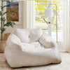 Plush beige bean bag chair with overstuffed backrest and armrests, perfect for relaxing or watching TV.