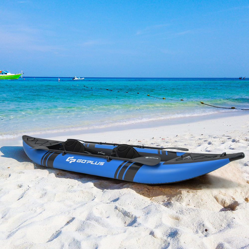 Inflatable 2-person kayak in blue on the beach, featuring durable aluminium oars and comfortable adjustable seats.