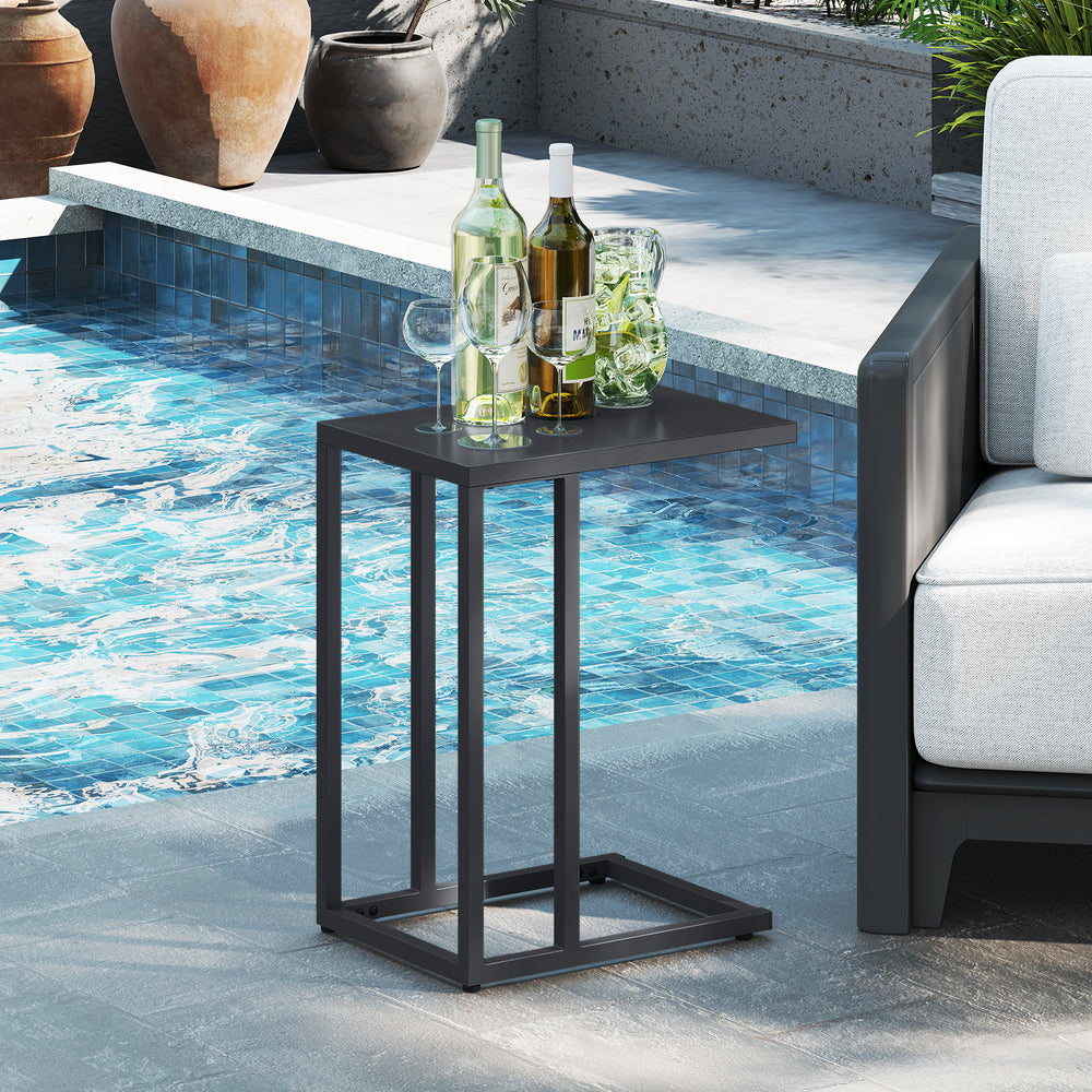 C-shaped side table in dark gray with spacious top, adjustable foot pads, ideal for indoor or outdoor use by the pool.