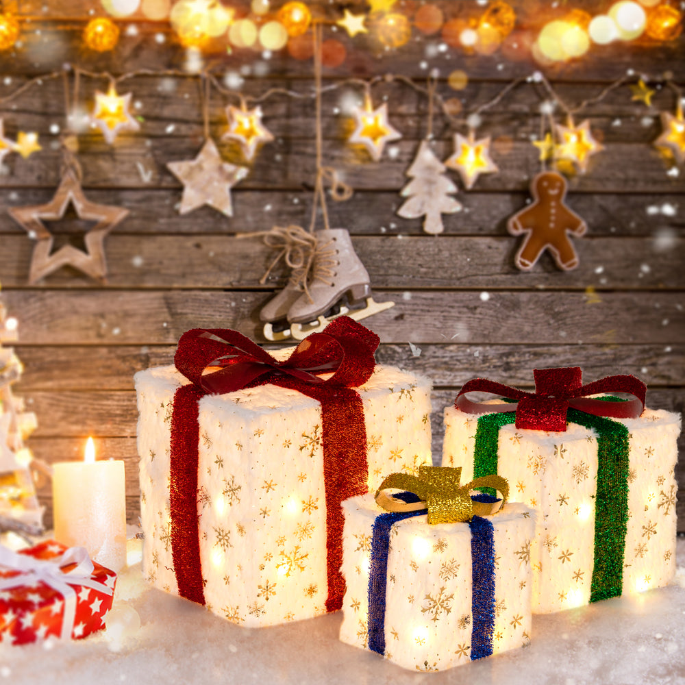 Large illuminated Christmas gift box with red ribbon and snowflake pattern, featuring 48 warm lights for festive decor.